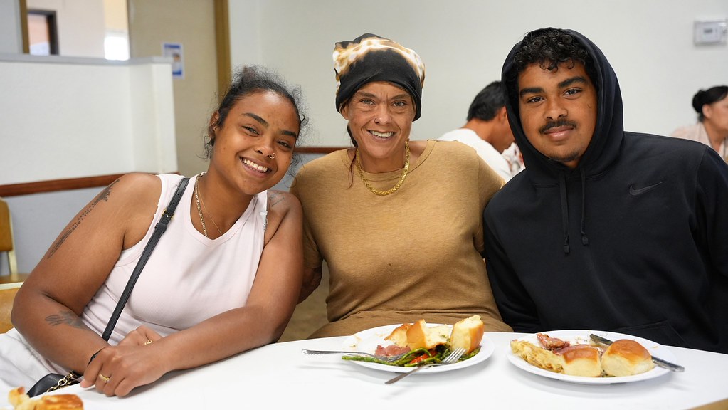 Three family members sharing a Thanksgiving meal